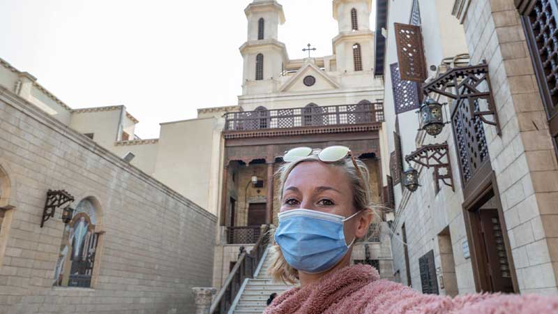 A picture of a female tourist in front of the Hanging Church